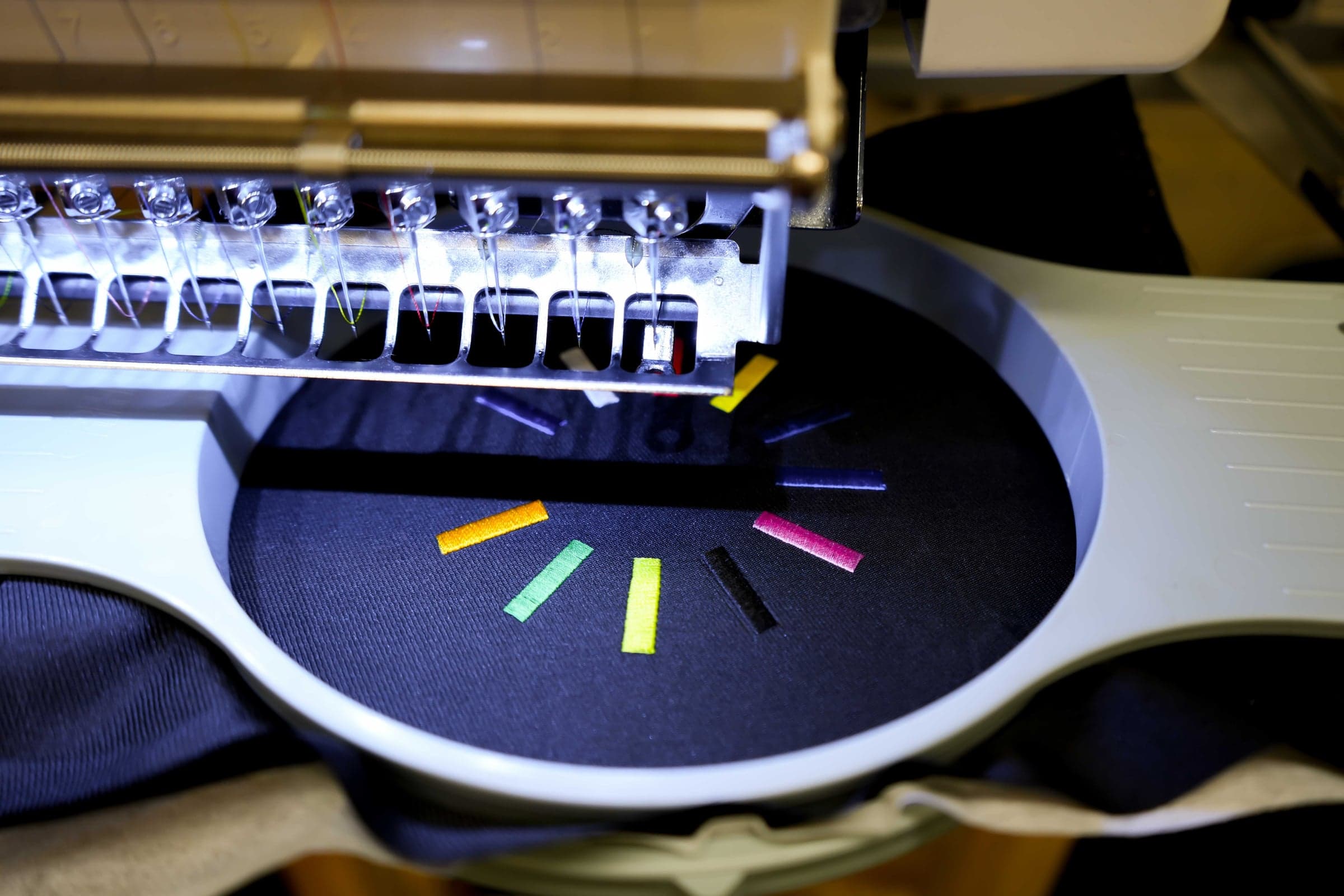 Commercial embroidery needle piercing fabric