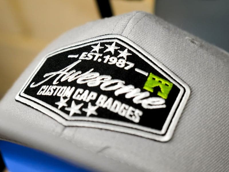 Production Result: Cap Letter-by-Letter | Contrasting outlines run letter-by-letter to maintain registration on curved frames.