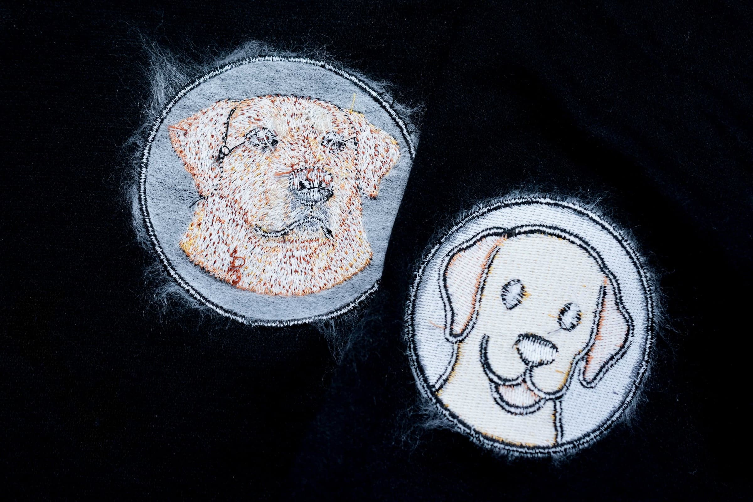 Two Labrador patches showing the front and the back of the stitching for comparison